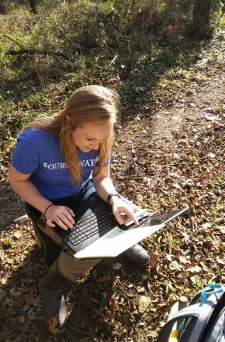 Picture of Abbie Lasater does a software check for the SonTek discharge meter.
